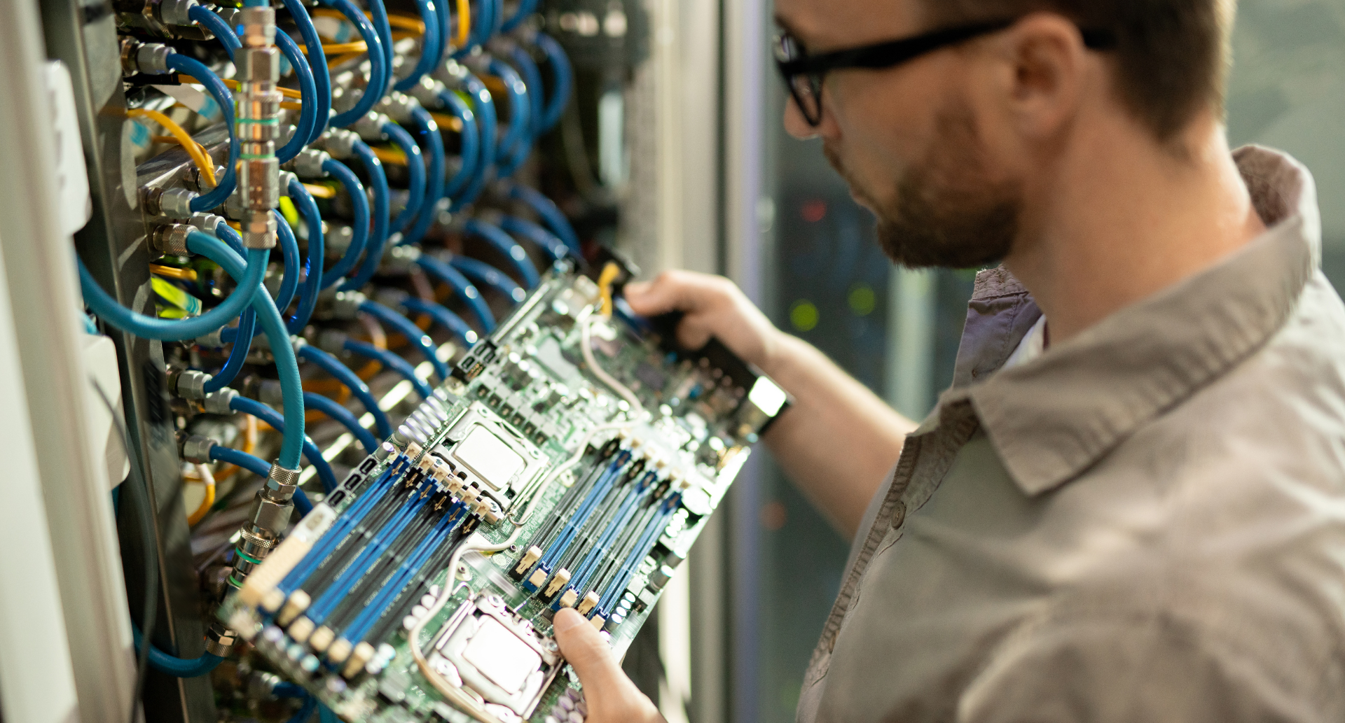 The specialist is likely performing maintenance, installation, or troubleshooting on the equipment. 